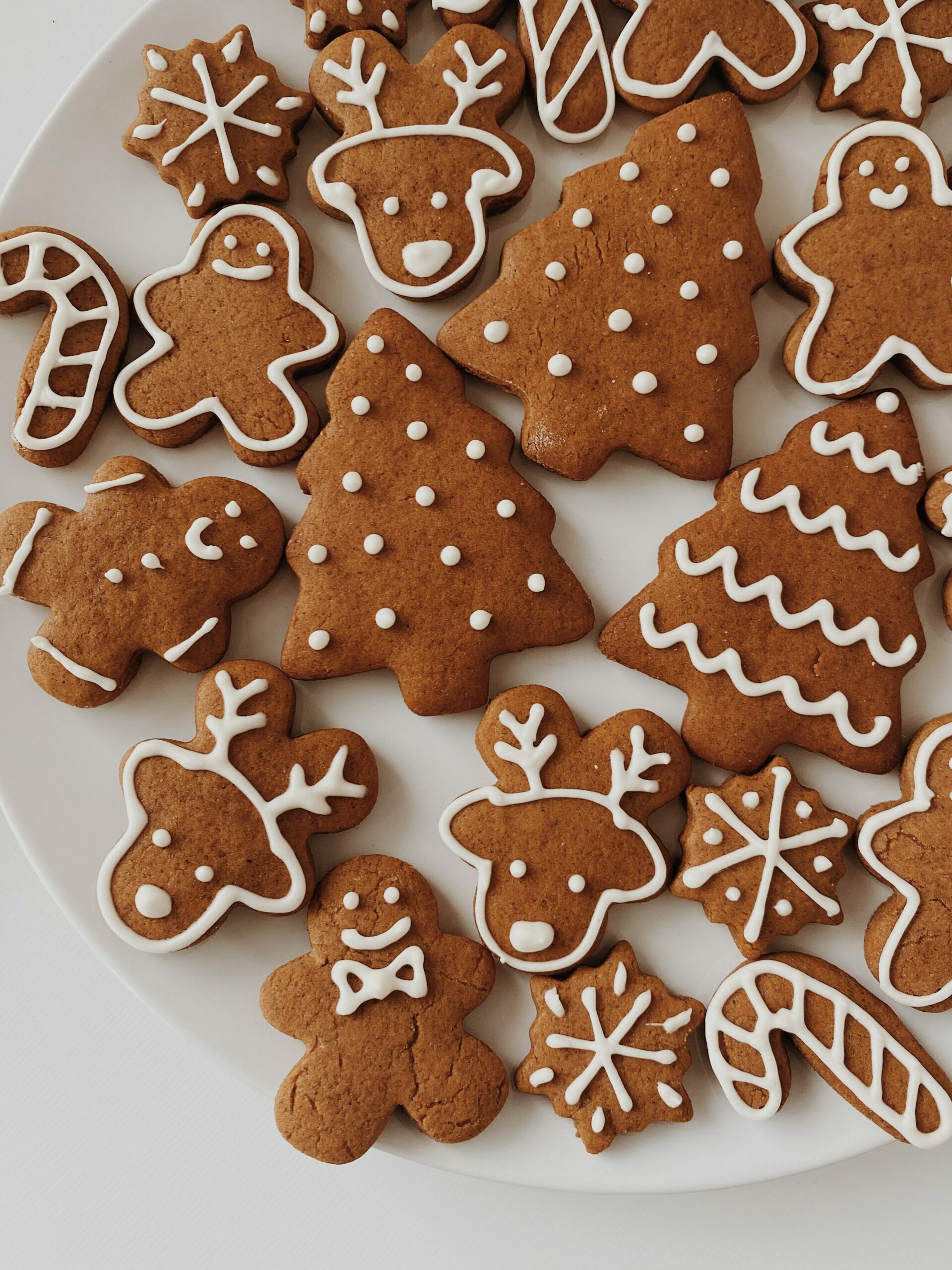 A plate of cookies with Christmas themed icing